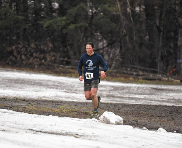 A member of Team AK-47 makes their way into the transition area after the adventure run during the Berkshire Highlands Pentathlon on Saturday at Berkshire East. 