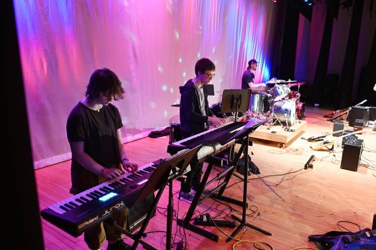 Keyboard players and a drummer from the Frontier Modern Band Class at Frontier Regional School perform for students in the auditorium last week.