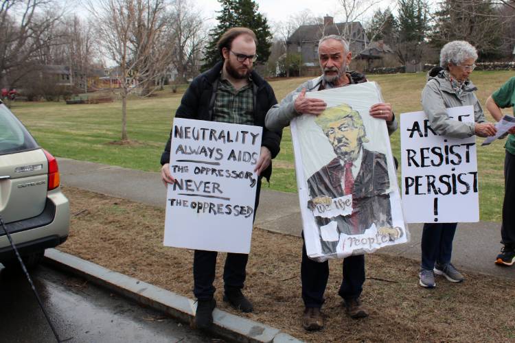 Protesters stand on the Ashfield town common on Saturday in opposition to the Trump administration.