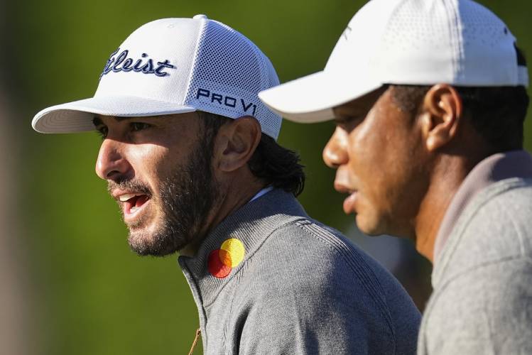 Max Homa and Tiger Woods walk on the 17th hole during the weather delayed first round round at the Masters golf tournament at Augusta National Golf Club Friday, April 12, 2024, in Augusta, Ga. (AP Photo/George Walker IV)