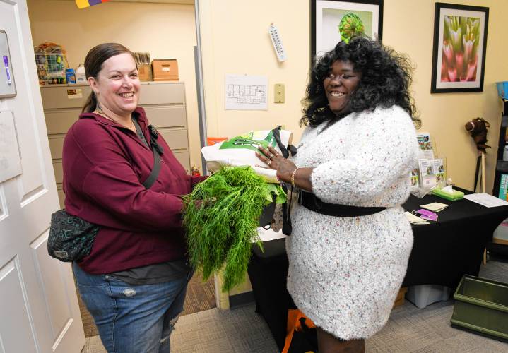 Greenfield resident Stephanie Gale picks up a meal for her family from Keyedrya Jacobs of the Communities That Care Coalition at the Family Resource Center at 90 Federal St. in Greenfield on Monday.