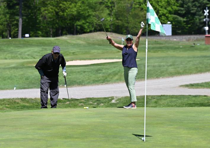 Greenfield resident Valerie Esquer celebrates as her birdie putt, from her second shot, drops at the first hole of the Greenfield Kiwanis Club’s golf tournament to benefit the Warm the Children charity in May. Looking on is Doug Fusonie of Greenfield. Greenfield resident Valerie Esquer celebrates as her birdie putt, from her second shot, drops at the first hole of the Greenfield Kiwanis Club’s golf tournament to benefit the Warm the Children charity in May. Looking on is Doug Fusonie of Greenfield.