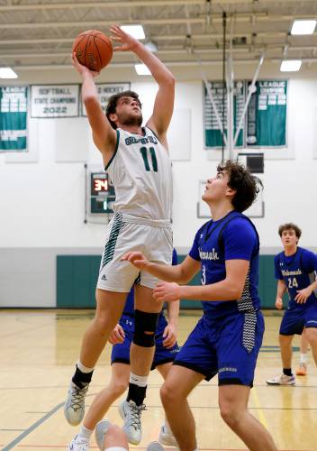 Greenfield’s Jonathan Breor (11) drives to the hoop over Wahconah’s Aidan Hagmaier (3)in the third quarter Saturday night in Greenfield.