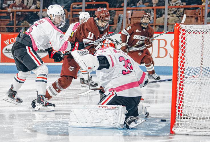UMass’ Lucas Mercuri (11) scores in the third period against Northeastern during the Minutemen’s 5-0 win on Friday night at Matthews Arena im Boston.