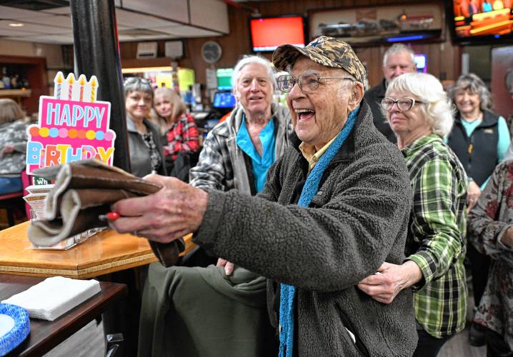 Lee Evers, who turned 102 on Feb. 12, center, at his birthday party at St. Kazimierz Society in Turners Falls. At left is his son, David Gladstone, and at right is his “adopted daughter” Linda Rice of Greenfield.