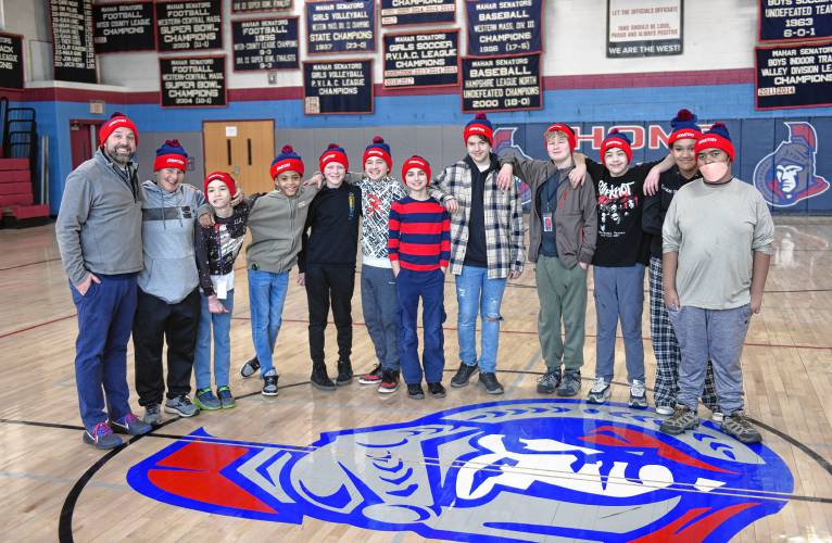 Ralph C. Mahar Regional School physical education teachers Kyle Magoffin and Tina Riddell, left, with their seventh grade class that helped name a Massachusetts Department of Transportation snowplow. Their winning name was Polar Pathmaker.