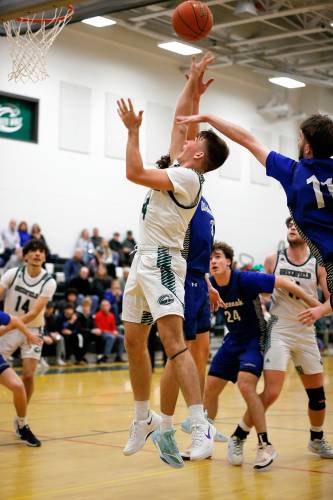 Greenfield’s Caleb Murray (4) drives to the hoop under pressure from Wahconah’s Aidan Hagmaier (3) and Jack Ducharme (11) in the fourth quarter Saturday night in Greenfield.