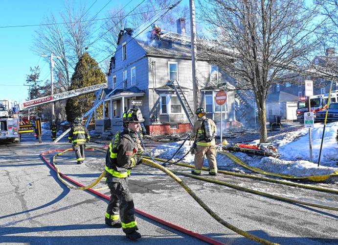 Firefighters bring an apartment house fire under control Sunday morning at 75 School St. in Greenfield.