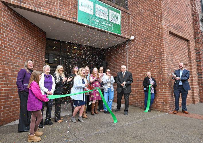 Owners Kimberly Williams with scissors, center, and her father Nicholas Waynelovich, with scissors at right, cut the ribbon for Ja’Duke on Main at 270 Main St. in Greenfield Thursday morning.