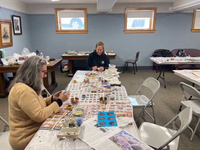 Northampton resident Amanda Nash and pysanky workshop co-leader Alex Osterman, of Ashfield, embellish their eggs during the workshop at Belding Memorial Library.