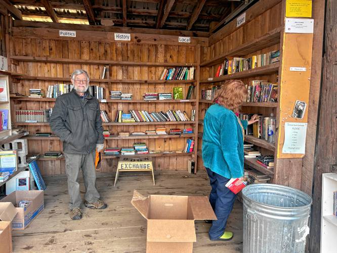 Frank Dufresne, at left, volunteers at the Ashfield Transfer Station’s book exchange.