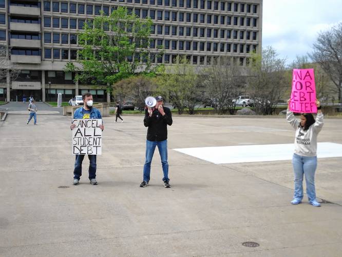 Aaron Liu, a graduate student at the University of Massachusetts, speaks as Ian Rhodewalt, left, field organizer for the Western Mass Area Labor Federation, and Jackie Daniels, a member-organizer with the Debt Collective, listen during a debt cancellation rally Wednesday at the Haigis Mall at the University of Massachusetts Amherst.
