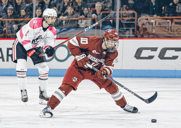 UMass’ Dans Locmelis (10) carries the puck into the Northeastern zone during the Minutemen’s 5-0 win on Friday night.