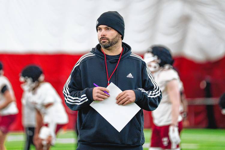 New UMass football coach Joe Harasymiak watches his team’s first practice of the spring on Monday in Amherst.