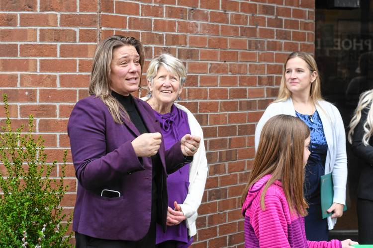 State Rep. Natalie Blais speaks as Greenfield Mayor Ginny Desorgher and Ja’Duke on Main owner Kimberly Williams listen at the ribbon cutting for Ja’Duke on Main at 270 Main St. in Greenfield on Thursday.