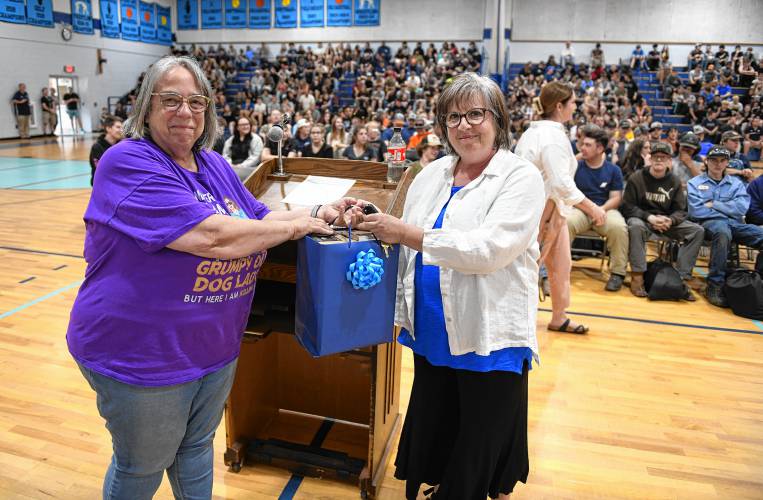 Franklin County Technical School programming and web development instructor Cyndi Bussey, left, accepts an Oculus 3 viewing device from Gill-Montague Senior Center volunteer Colleen Doherty on Thursday as thanks for the students helping Senior Center members with their electronic devices.