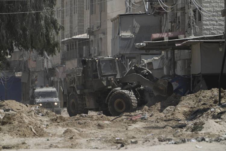 A front-end loader from the Israeli forces moves on a street during a military operation on Aug. 29 in the West Bank refugee camp of Nur Shams, Tulkarem.