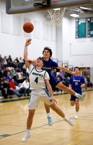 Greenfield’s Caleb Murray (4) gets fouled on a breakaway layup by Wahconah’s Aidan Hagmaier (3) in the fourth quarter Saturday night in Greenfield.