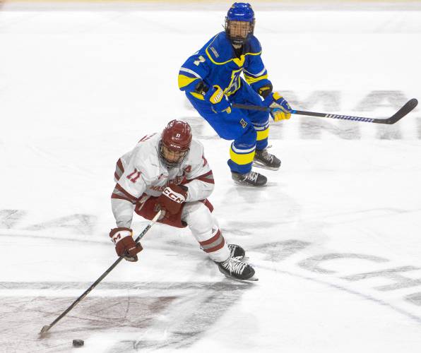 UMass center Lucas Mercuri (11) keeps the puck from Alaska defenseman Broten Sabo (7) during the NCAA hockey game at the Mullins Center, Friday, Jan. 24, 2025, in Amherst.