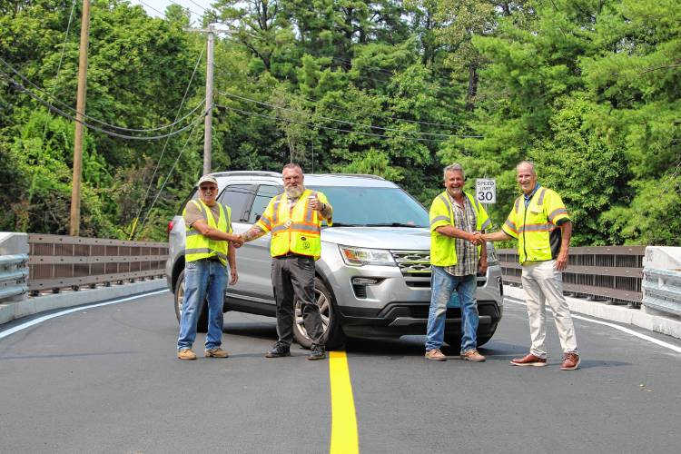 State bridge inspector Herbie Pierce, from left, Assistant Public Works Superintendent Paul Raskevitz, Construction Dynamics Superintendent Bob Ciampaglia and Public Works Superintendent Dick Kilhart on the Pinedale Avenue Bridge on Aug. 15, when it was reopened.