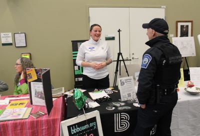 Abbe Bresciano of Big Brothers Big Sisters of Western Massachusetts talks with Greenfield Police Officer Zoe Smith at Greenfield Community College’s Involvement Expo Wednesday evening. The event was designed to showcase opportunities for residents to join social and civic associations, nonprofits, sports and hobby clubs, mutual aid and other community-building groups.
