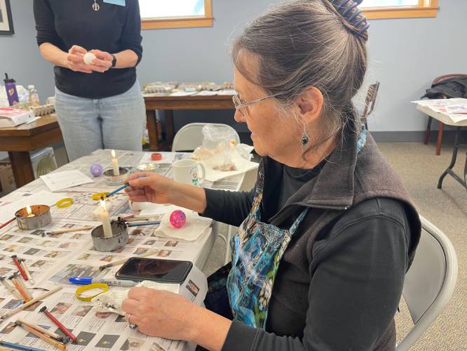 Longtime Ashfield resident Mary Link demonstrates the first step of pysanky, melting the beeswax in the kistkas, during a workshop at Belding Memorial Library.