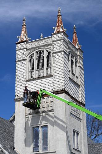 Employees of R.G. Penfield & Sons Inc. repair weather-worn exterior details of the steeple of the First United Methodist Church in Greenfield recently. Employees of R.G. Penfield & Sons Inc. repair weather-worn exterior details of the steeple of the First United Methodist Church in Greenfield recently.