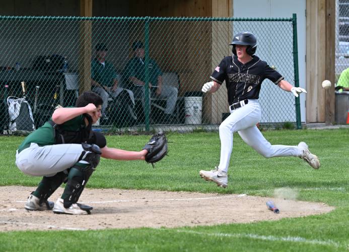 Pioneer’s Jackson Campbell scores as the throw to Greenfield catcher Luca Siano hits the bat on the ground at Vets Field Wednesday.