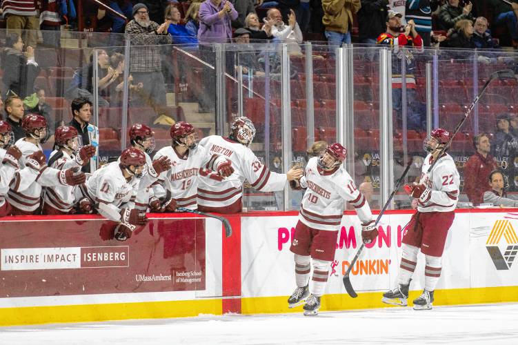UMass center Dans Locmelis (10) high-fives his teammates after scoring a goal during the NCAA hockey game against Alaska at the Mullins Center, Friday, Jan. 24, 2025, in Amherst.