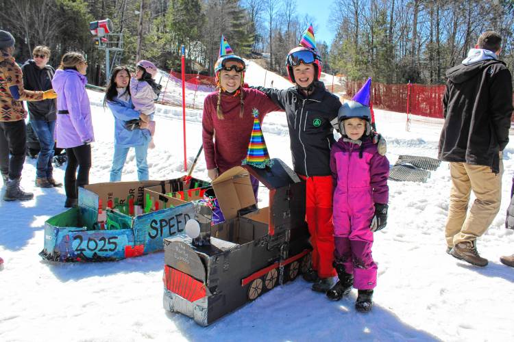 Juniper and Lulu Tortino of Charlemont and Reese Schaefer of Hawley with their sled, “The Party Express,” at Berkshire East Mountain Resort in Charlemont on Sunday.