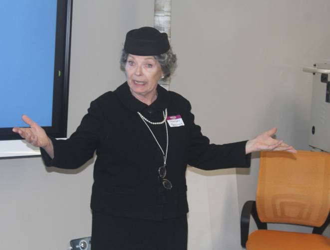 Actress and University of Massachusetts Amherst Professor Emerita Jarice Hanson performs as Frances Perkins, a Massachusetts native and Mount Holyoke College graduate who became the first woman ever to serve in a presidential cabinet, during an open house at The Literacy Project’s Orange location on Thursday.