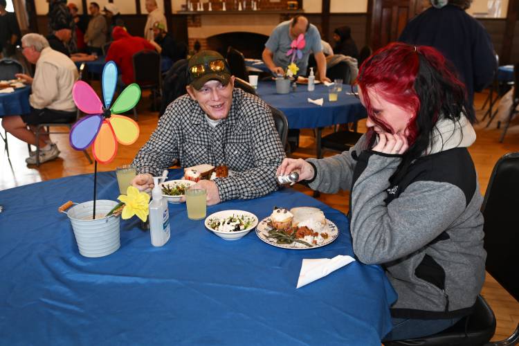 Michael Sumner and Trisha Pecor of Greenfield enjoy a hot meal at Second Helpings, a community meal, at the Episcopal Church of Saints James and Andrew in Greenfield.