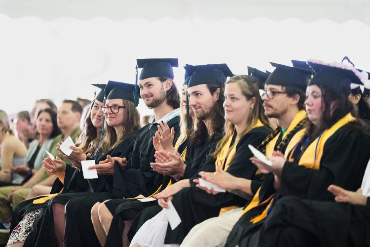 Greenfield Community College graduates give some applause at Saturday’s commencement ceremony.