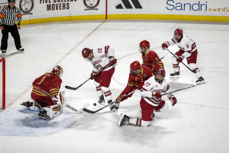 UMass forward Cole O'Hara (19) fights for the puck in front of the Boston College net in the first period Friday night at the Mullins Center.