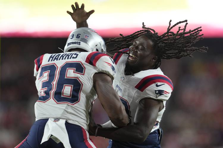 New England Patriots running back Kevin Harris (36) is congratulated by running back Rhamondre Stevenson after scoring against the Washington Commanders during the first half of a preseason NFL football game, Sunday, Aug. 25, 2024, in Landover, Md. (AP Photo/George Walker IV)