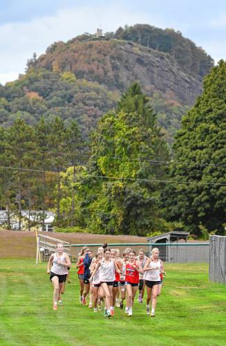 The Frontier girls soccer team jogs around Herlihy Park in Whately last week, with a touch of fall showing on Mount Sugarloaf in the background.
