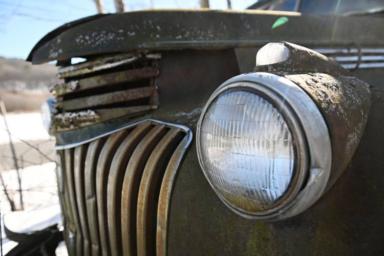 The grill and headlight of an old Chevrolet truck on Meadow Road in Montague on a recent day.