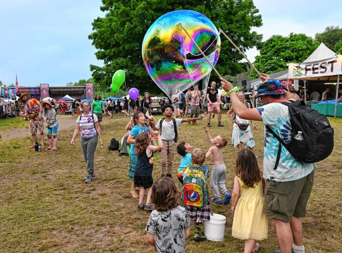 A volunteer entertains children with bubbles at the 20th StrangeCreek Campout at Camp Kee-wanee in Greenfield.