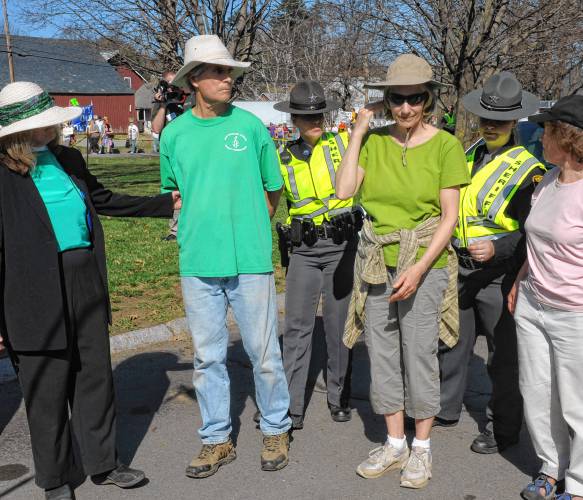 Randy Kehler, center, and Betsy Corner, right, were the first to cross the line and subject themselves to arrest during a Vermont Yankee Nuclear Power Plant protest in 2012.