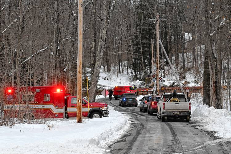 A freight train blocks the Farley Road crossing in Wendell on Tuesday afternoon, with 15 of its freight cars derailed just west of the crossing.  