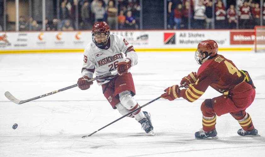 UMass defenseman Owen Murray (26) keeps the puck from Boston College forward Teddy Stiga (4) during action last month in Amherst.