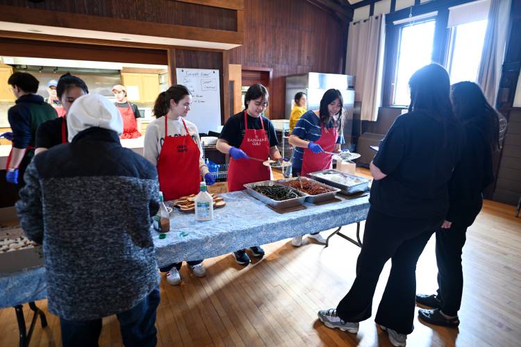 Deerfield Academy students serve Second Helpings, a community meal, at the Episcopal Church of Saints James and Andrew in Greenfield.