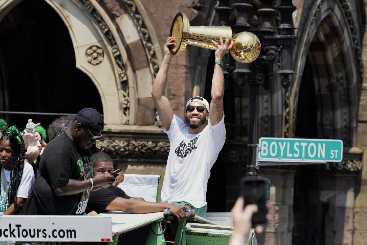 Boston’s Jayson Tatum celebrates the team's NBA championship during a duck boat parade Friday in Boston.