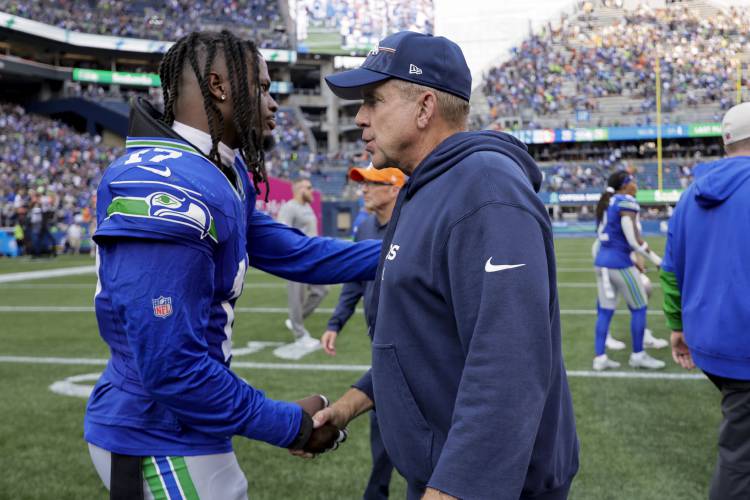Denver Broncos head coach Sean Payton shakes hands with Seattle Seahawks linebacker Jerome Baker (17) after an NFL football game Sunday, Sept. 8, 2024, in Seattle. The Seattle Seahawks won 26-20. (AP Photo/John Froschauer)