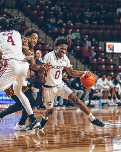 UMass sophomore guard Jaylen Curry (0) maneuvers around a Shahid Muhammad (4) screen during the first half of the Minutemen’s 00-00 loss to Loyola Chicago on Saturday afternoon at Mullins Center in Amherst.