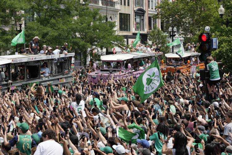The Boston Celtics celebrate their NBA championship win with a duck boat parade Friday in Boston.