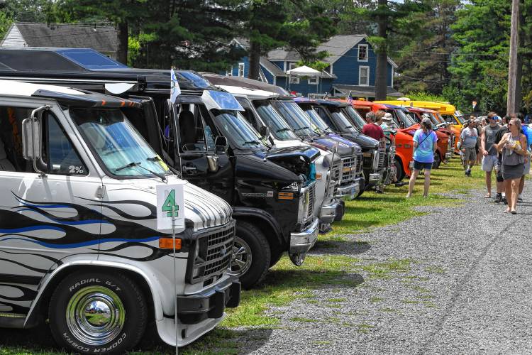 Enthusiasts check out row after row of custom vans at the National Truck-In event at the Franklin County Fairgrounds in Greenfield on Friday.