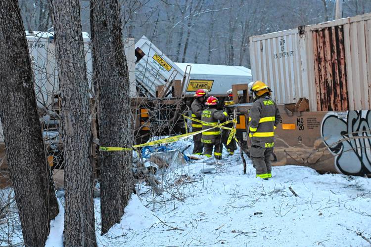 Wendell firefighters put up caution tape at a train derailment parallel to Farley Road in Wendell on Tuesday afternoon.