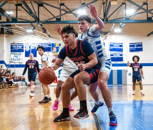 Mahar's Jayden Delgado, left, keeps the ball from Granby's Sawyer Clarke, right, during the PVIAC Class C tournament semifinal game at Granby High School, Tuesday, Feb. 18, 2025, in Granby.
