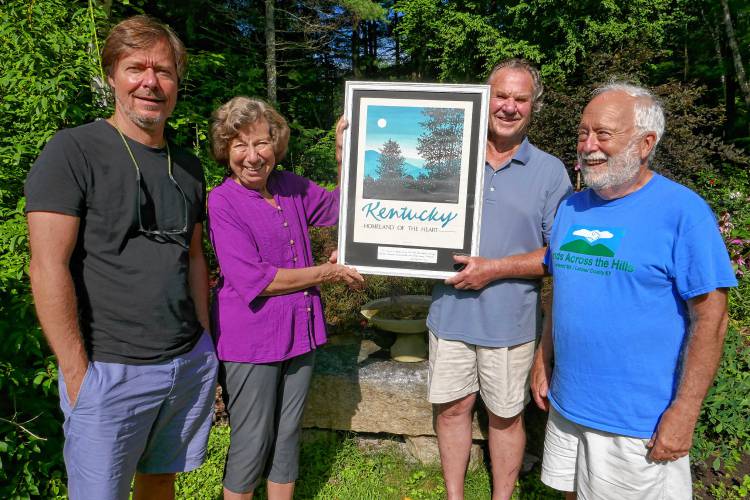 Filmmaker Jorg Daniel Hissen, left, with Paula Green, Jim Perkins and Tom Wolff, look at a poster of Kentucky presented to the town of Leverett from the Hands Across the Hills project in September 2018. Filmmaker Jorg Daniel Hissen, left, with Paula Green, Jim Perkins and Tom Wolff, look at a poster of Kentucky presented to the town of Leverett from the Hands Across the Hills project in September 2018.